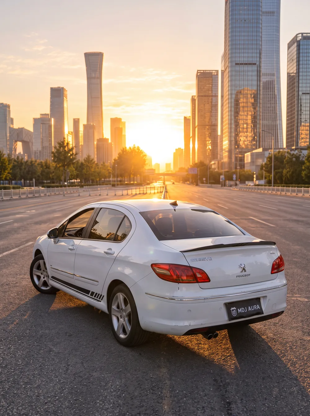 A silver car on a city avenue at sunset