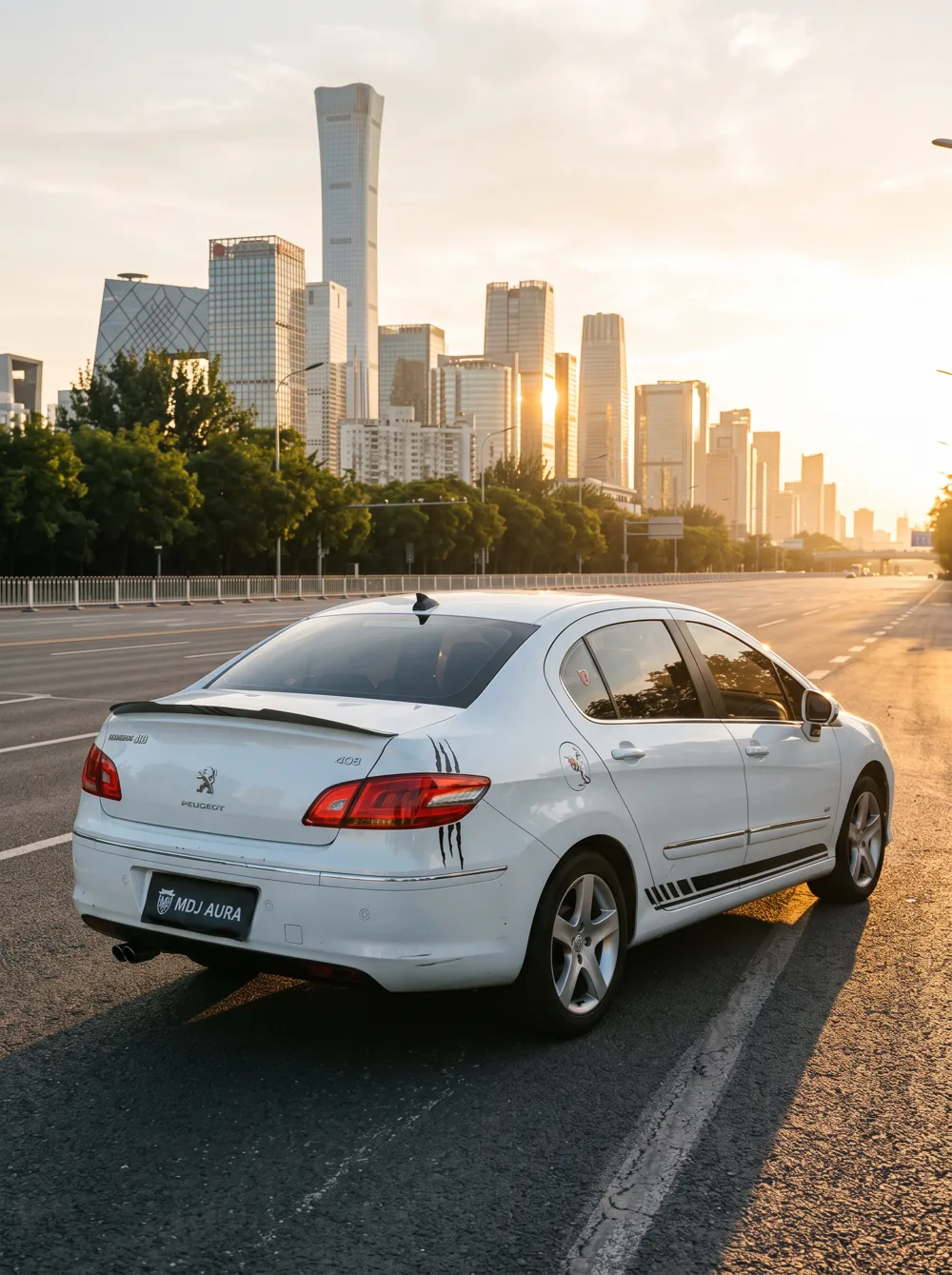 A silver car on a city avenue at sunset