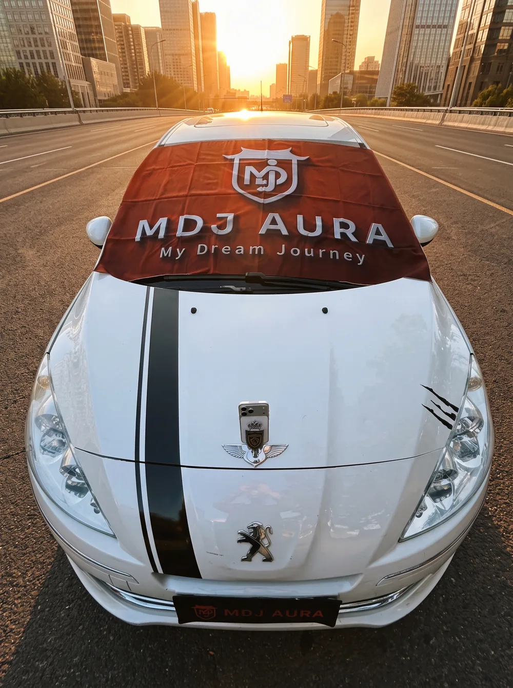 A silver car on a city avenue at sunset