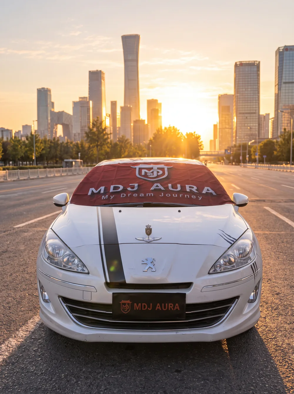 A silver car on a city avenue at sunset
